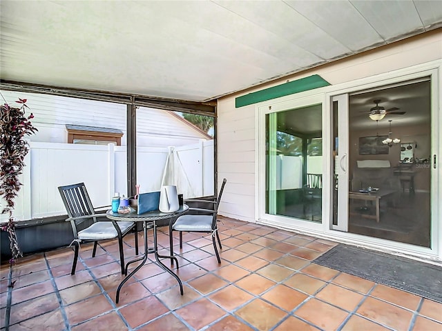 sunroom featuring ceiling fan