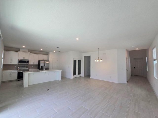 1162 Happy Forest Loop, Deland, FL 32720 - unfurnished living room with a chandelier, recessed lighting, and a sink