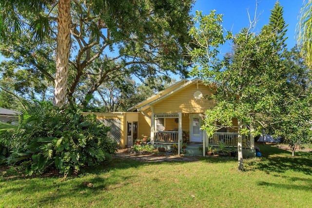 view of front of house with a front yard and a porch