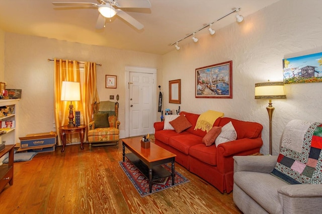 living room with hardwood / wood-style flooring, track lighting, and ceiling fan