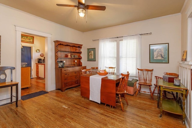 dining room featuring ceiling fan, crown molding, and wood-type flooring