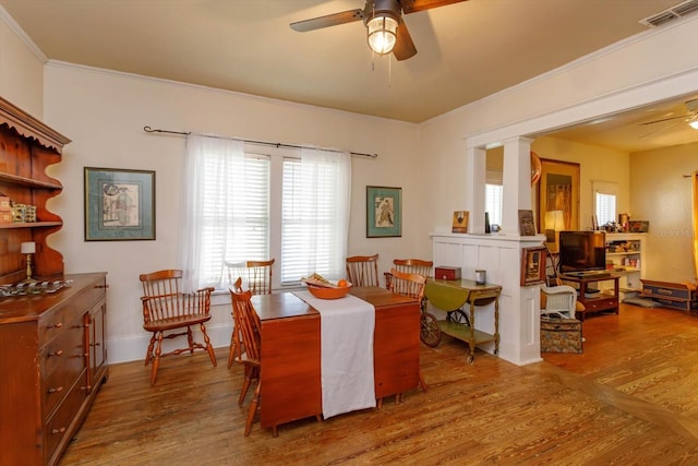 dining area with hardwood / wood-style floors, ceiling fan, and ornamental molding