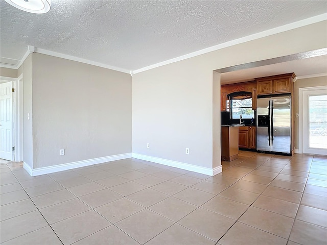 1037 Poinsetta St, Cocoa, FL 32927 - spare room featuring crown molding, a textured ceiling, light tile patterned floors, baseboards, and a sink