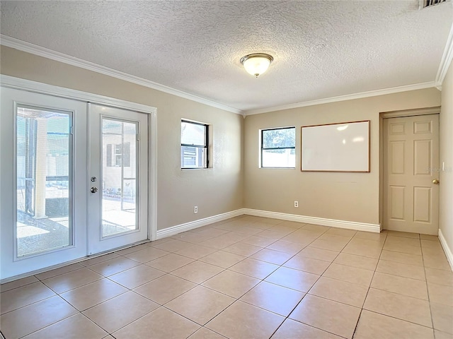 empty room featuring crown molding, french doors, and light tile patterned floors