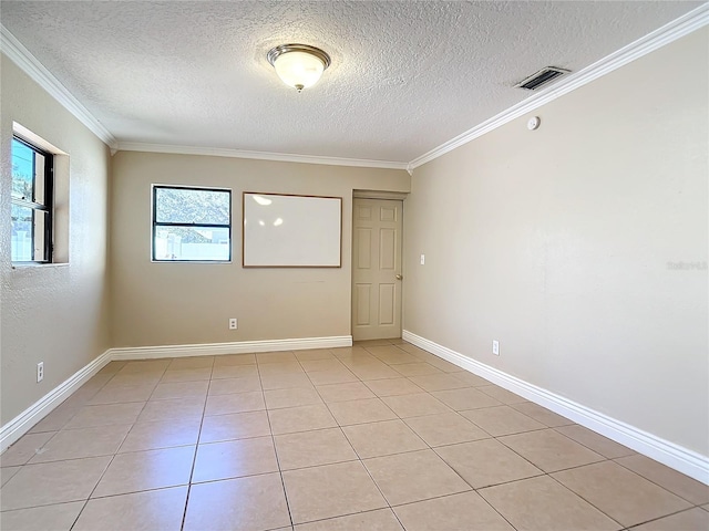 tiled empty room featuring a textured ceiling and crown molding