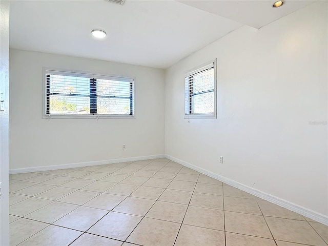 1037 Poinsetta St, Cocoa, FL 32927 - unfurnished room featuring plenty of natural light, light tile patterned floors, baseboards, and recessed lighting