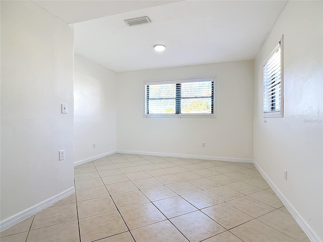 unfurnished room featuring light tile patterned floors