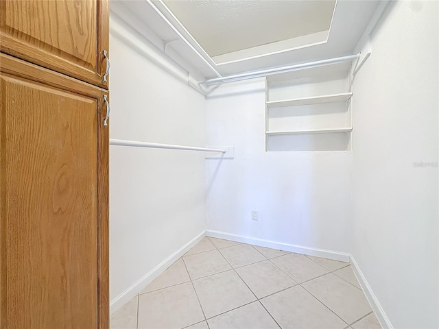 spacious closet with light tile patterned floors