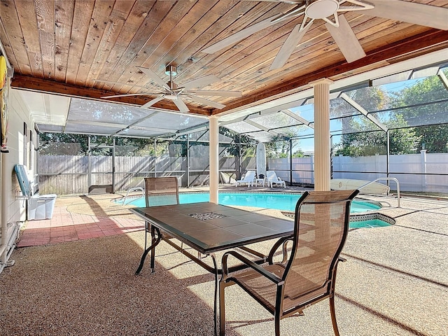 view of swimming pool featuring glass enclosure and a patio area