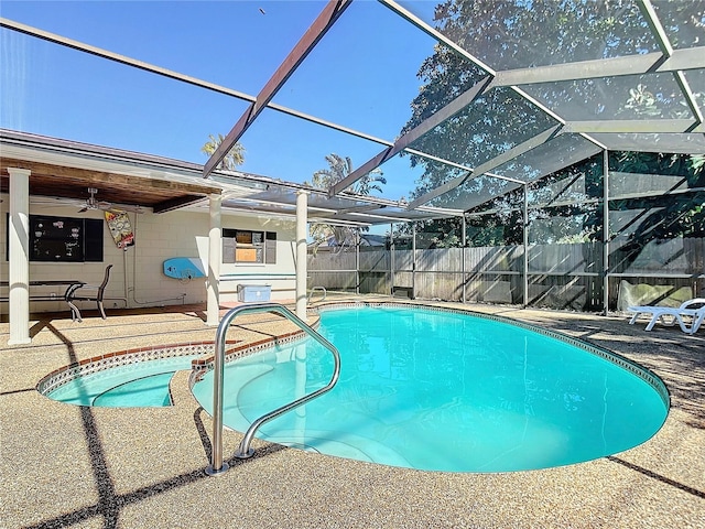 view of pool with a lanai, ceiling fan, and a patio