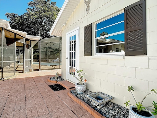 view of patio with a lanai and a pool