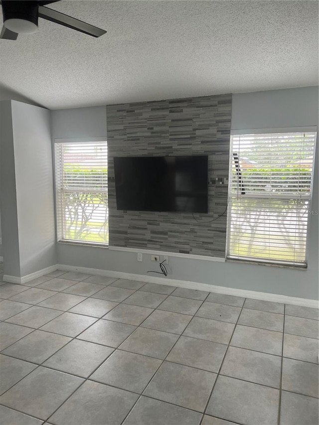 interior details with ceiling fan and a textured ceiling