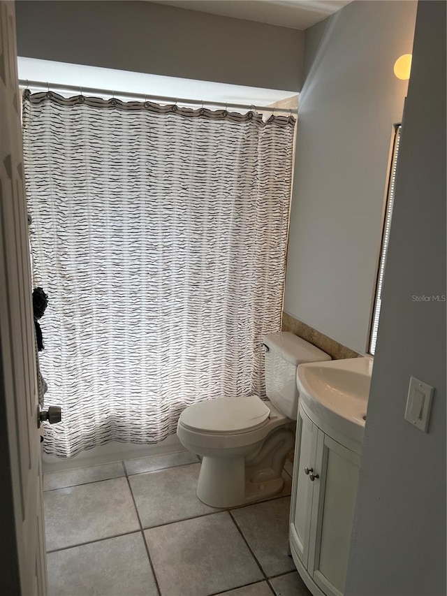 bathroom with tile patterned flooring, vanity, toilet, and a shower with shower curtain