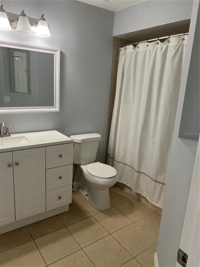 bathroom featuring toilet, vanity, and tile patterned floors