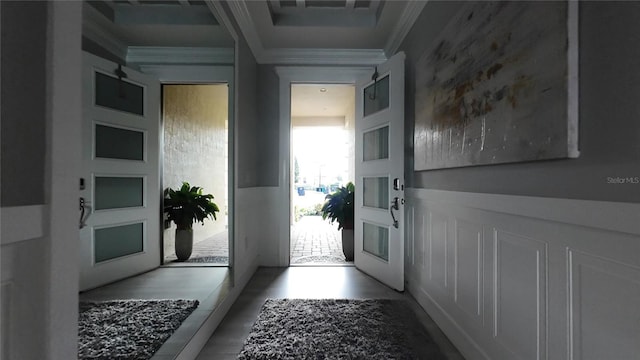 doorway to outside featuring ornamental molding