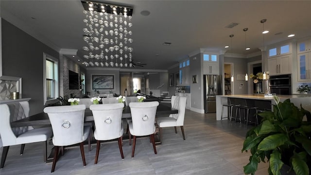 dining area with ceiling fan and ornamental molding