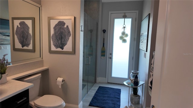 bathroom with an enclosed shower, vanity, toilet, and tile patterned floors