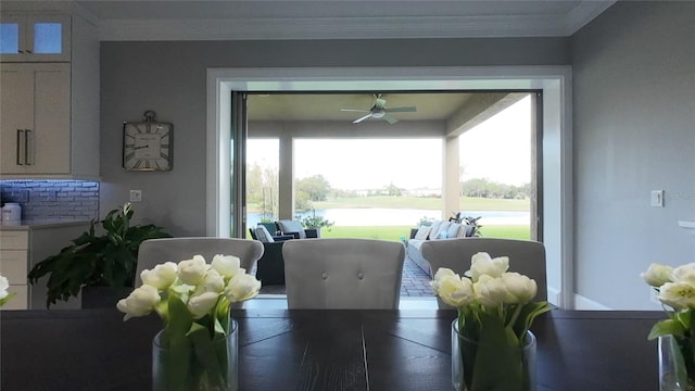 dining space with a wealth of natural light, ceiling fan, and ornamental molding