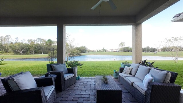 view of patio / terrace featuring ceiling fan, a water view, and an outdoor hangout area