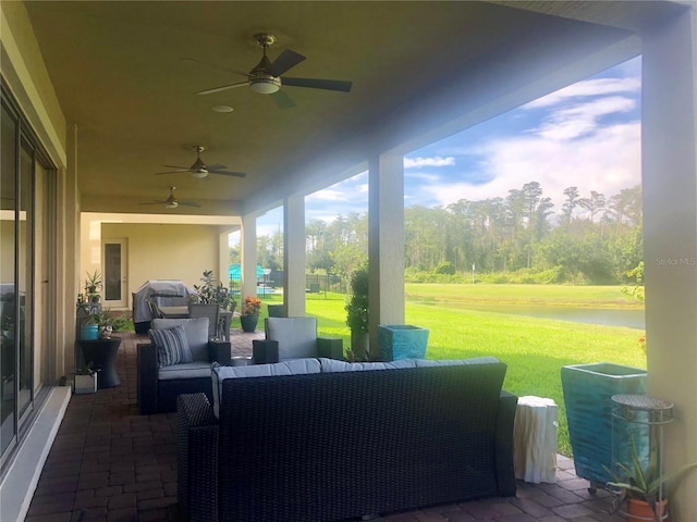 view of patio with ceiling fan, an outdoor hangout area, and grilling area