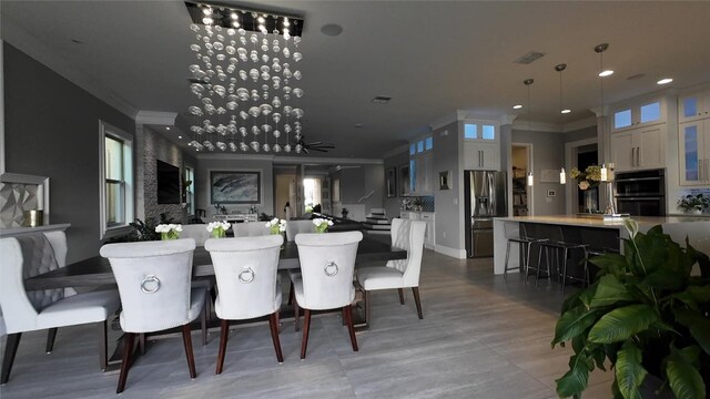 dining room with ceiling fan and ornamental molding