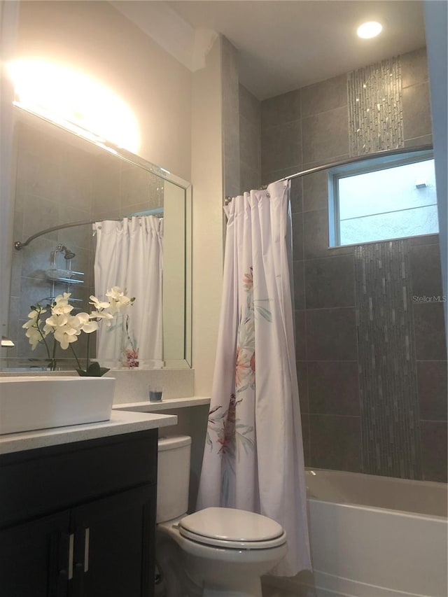 full bathroom with vanity, toilet, and shower / bath combo with shower curtain