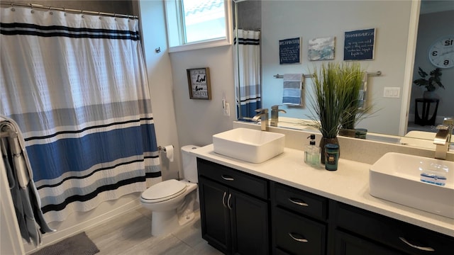 full bathroom with toilet, shower / bath combo with shower curtain, vanity, and hardwood / wood-style flooring