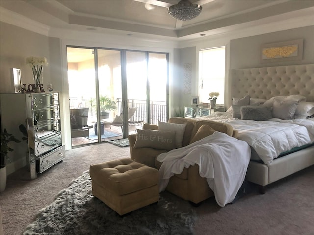 bedroom with access to exterior, carpet floors, crown molding, and a tray ceiling