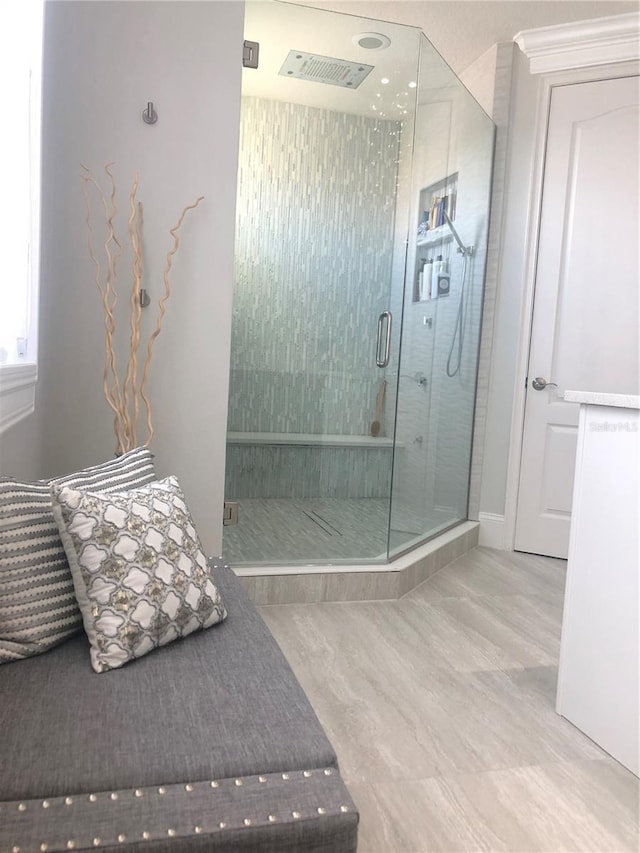 bathroom featuring a shower with shower door