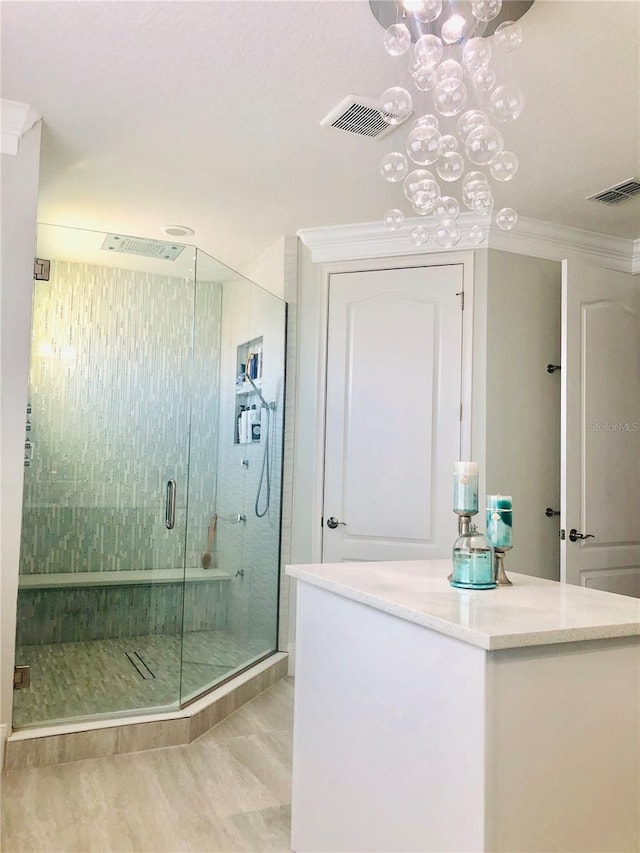 bathroom with ornamental molding and walk in shower