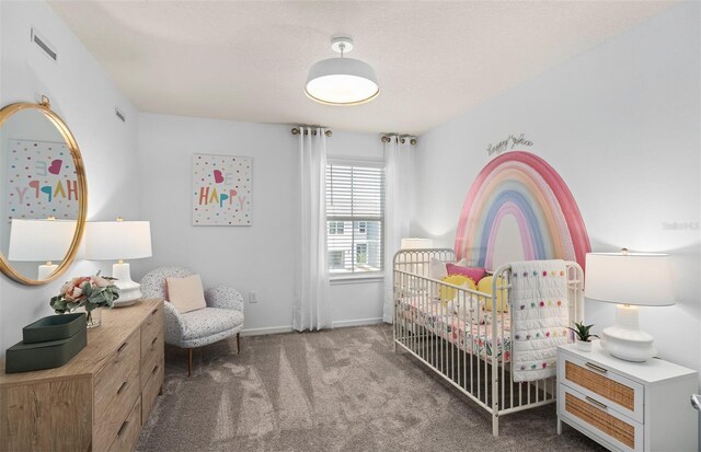 carpeted bedroom featuring a crib