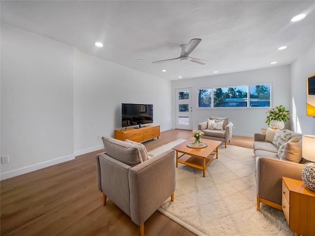 living room with light hardwood / wood-style floors and ceiling fan