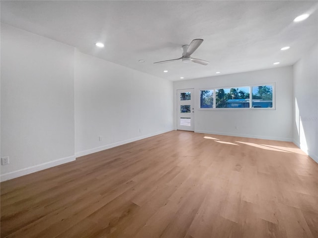 spare room featuring light hardwood / wood-style flooring and ceiling fan