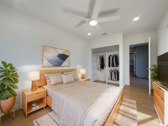 bedroom with a closet, ceiling fan, and light hardwood / wood-style flooring