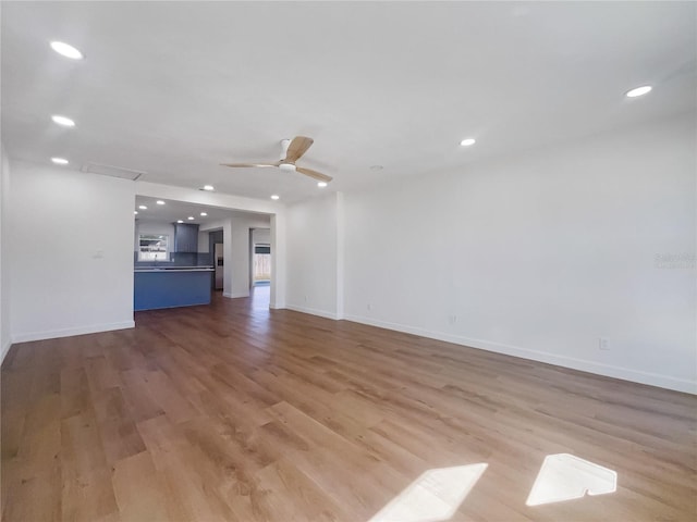 unfurnished living room featuring light hardwood / wood-style flooring and ceiling fan