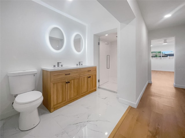 bathroom with walk in shower, hardwood / wood-style flooring, vanity, and toilet