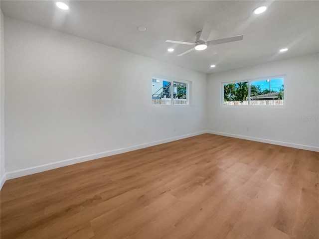 spare room with light hardwood / wood-style flooring and ceiling fan