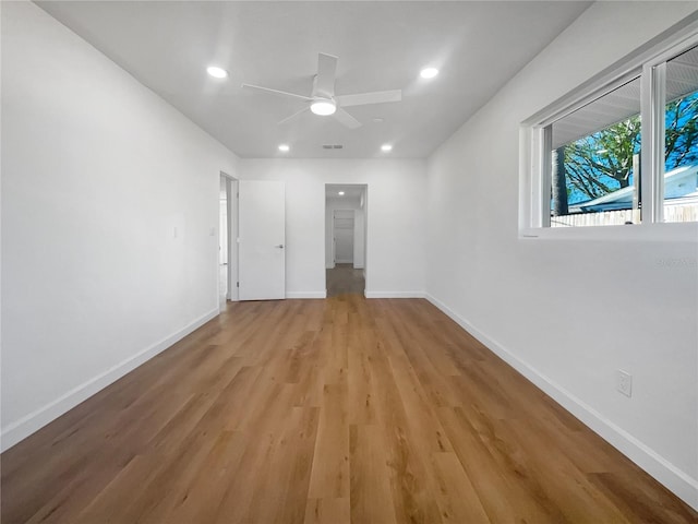 unfurnished bedroom with ceiling fan and light hardwood / wood-style floors