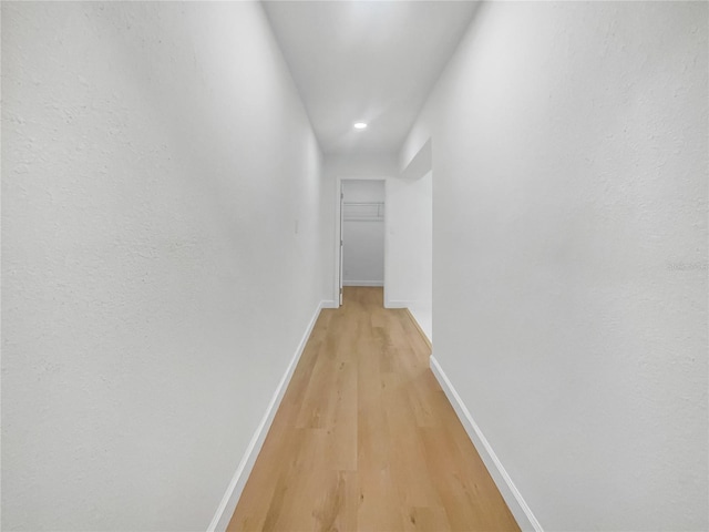 corridor with light hardwood / wood-style flooring