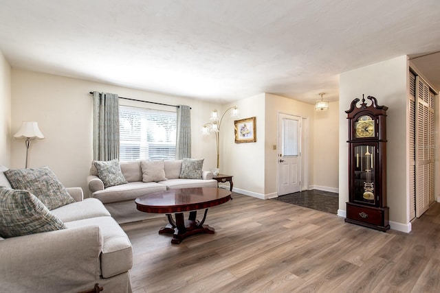 living area featuring baseboards and wood finished floors