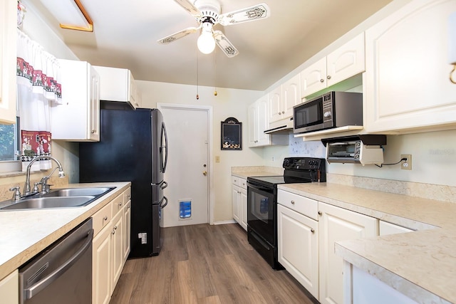 kitchen featuring stainless steel appliances, light countertops, white cabinetry, and a sink