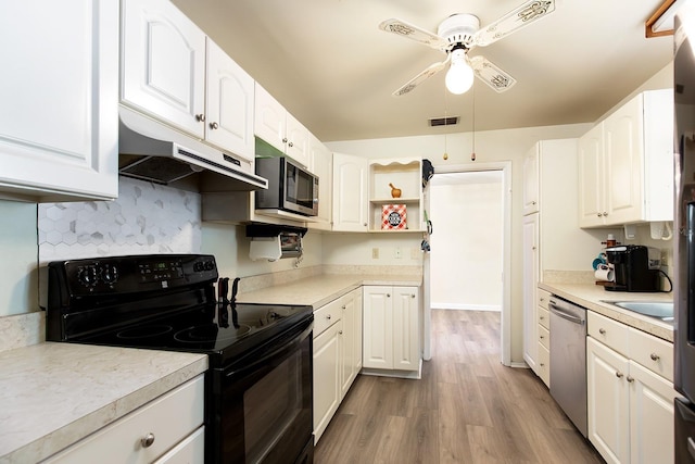 kitchen with white cabinets, stainless steel appliances, visible vents, and under cabinet range hood