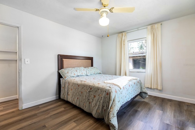 bedroom with wood finished floors, a ceiling fan, and baseboards