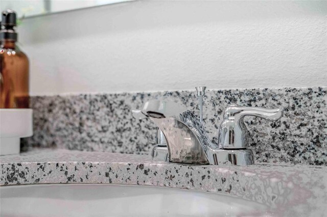 418 St Johns Ln, Kissimmee, FL 34759 - bathroom view of tasteful backsplash, a sink, and toilet