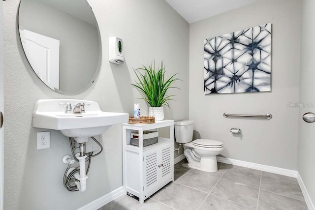 bathroom with tile patterned floors and toilet