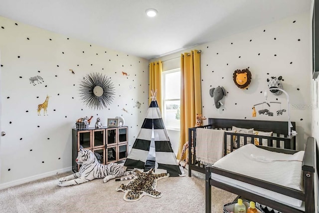 bedroom featuring a crib and carpet flooring