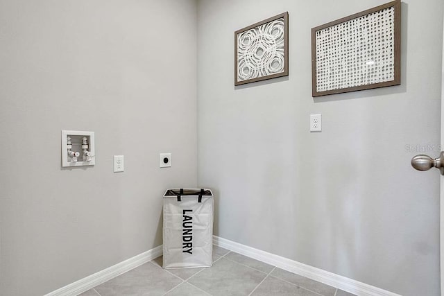 laundry area with washer hookup, electric dryer hookup, and light tile patterned flooring