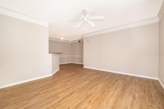 empty room featuring light wood-type flooring, ceiling fan, and crown molding