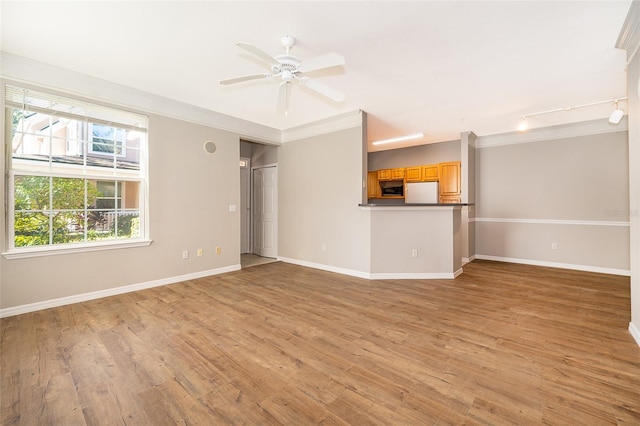 unfurnished living room with light hardwood / wood-style floors, ceiling fan, and crown molding