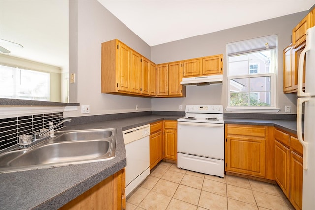 kitchen featuring light tile patterned flooring, white appliances, and sink